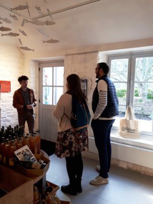 Hugo Michel, 2022 museum trainee with visitors in the shop